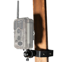 Heavy-duty trail camera tree mount clamp securing a camera to a wooden post.