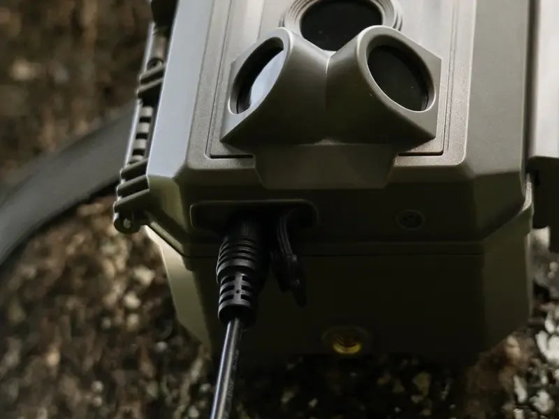Close-up of the weatherproof power port on a GardePro X66 Pro cellular trail camera